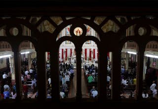 People attend a memorial held for the deceased crew members of the Air India Boeing 787-8 Dreamliner plane, which crashed during take-off from an airport in Ahmedabad, at a church in Mumbai, India